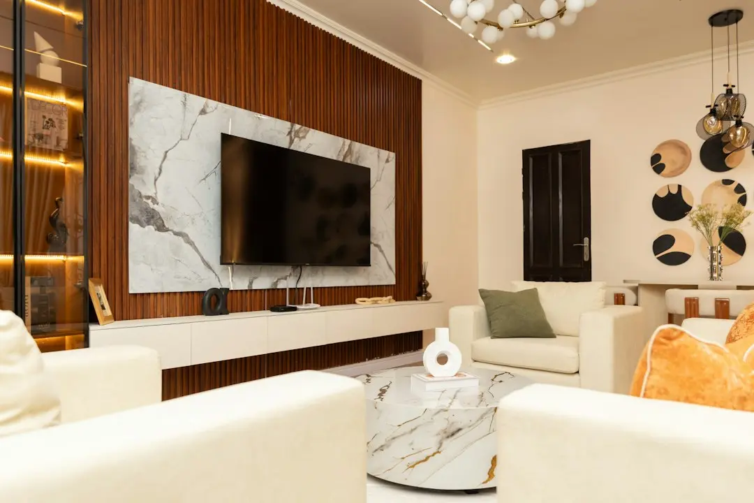 A large wall-mounted TV in a modern living room, the kind of screen used for Lux IPTV in 4K