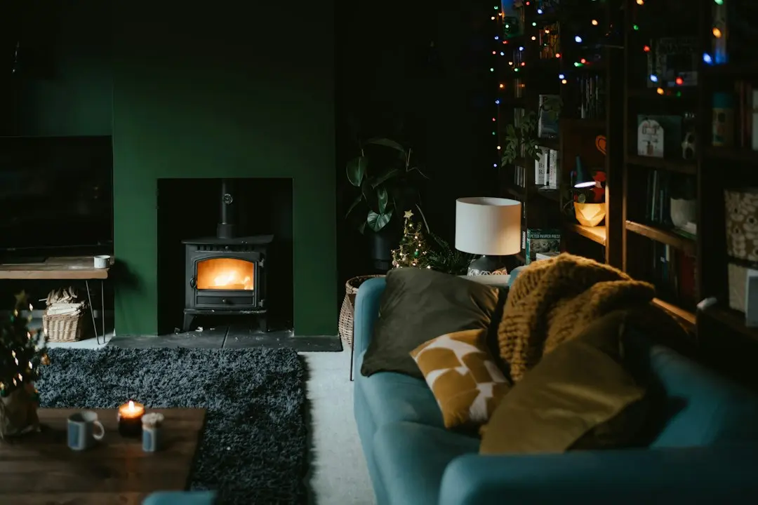 A dark living room with a switched-off TV beside a wood stove, ready for Lux IPTV on Firestick